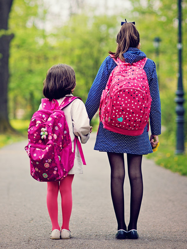Two students walking to school.