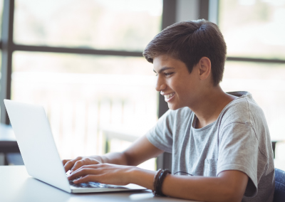 Boy typing on a computer. 