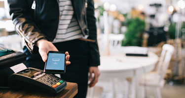 Person making a wireless purchase with their phone. 